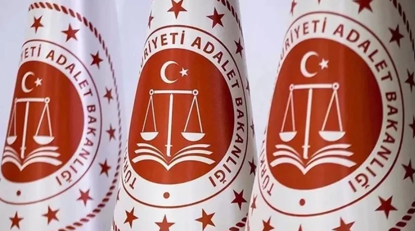 Seal of the Turkish Ministry of Justice showing scales of justice above an open book, with crescent and star, surrounded by stars.