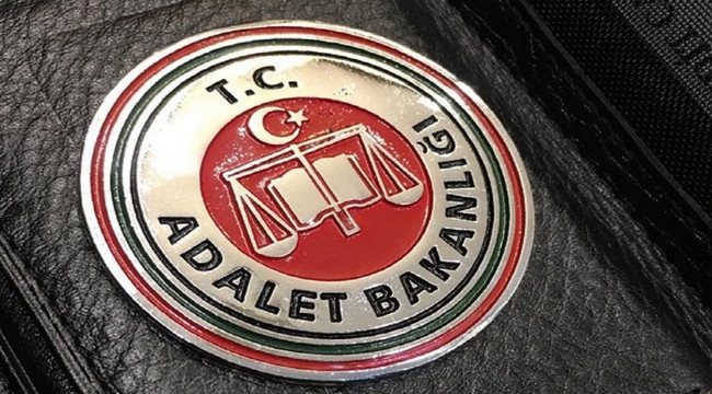 Circular badge for the Turkish Ministry of Justice (T.C. Adalet Bakanlığı) with a red center and emblem on a black surface.